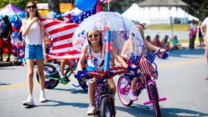 A contestant rides a very decorated bicycle.