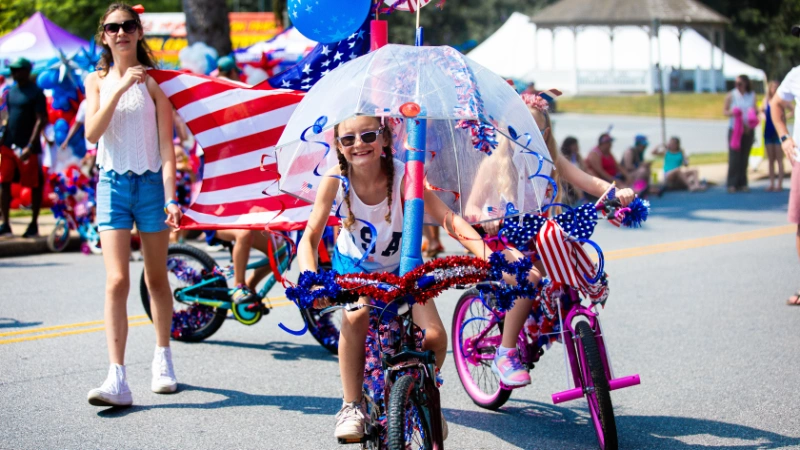A contestant rides a very decorated bicycle.