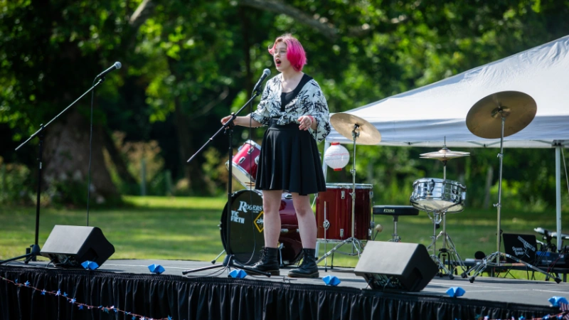 A young singer performs on a stage during Downingtown Has Talent in 2024.