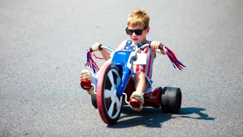 A young boy rides in the Big Wheel Race
