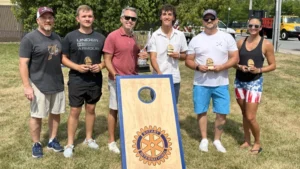 Winners of the Cornhole Madness Tournament posing with the trophy.